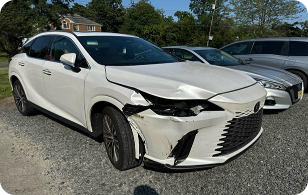 Before auto body repair - White SUV with front-end damage